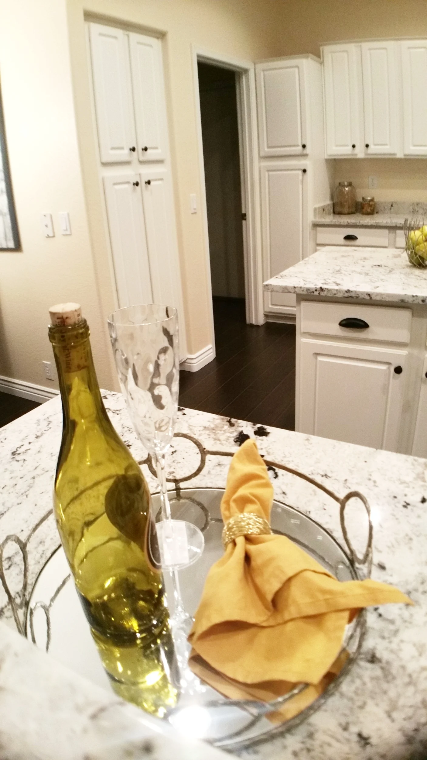 Wider view of the granite peninsula showing the stone splashback rail and the corner sink run