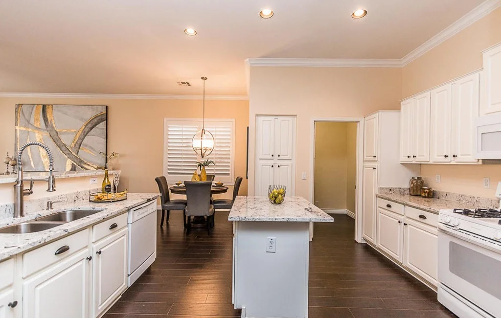 Remodeled kitchen and bathroom by Decoriam showing matching stone surfaces and cabinetry finishes